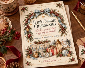 May include: A cream-colored Christmas planner titled Il mio Natale Organizzato with a festive border of pine branches, red berries, and a blue ribbon. The cover features illustrations of wrapped gifts, a lantern, and the text Natale 2026.
