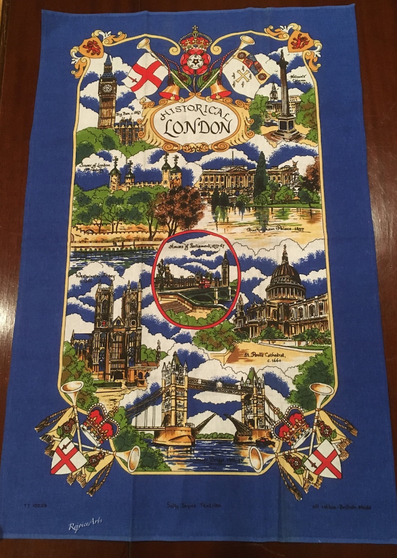 May include: A blue tea towel with a colorful illustration of historical landmarks in London, England. The illustration includes Big Ben, Houses of Parliament, St. Paul's Cathedral, and Tower Bridge. The text "HISTORICAL LONDON" is printed in a decorative font.