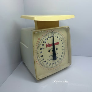 May include: A vintage white kitchen scale with a black needle and a red dial that reads "Hamilton" and "General Scale".