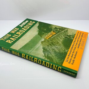 May include: A green hardcover book titled "This Was Railroading" with a yellow spine. The book cover features a vintage photograph of a train traveling through a mountainous landscape. The book is published by Bonanza.