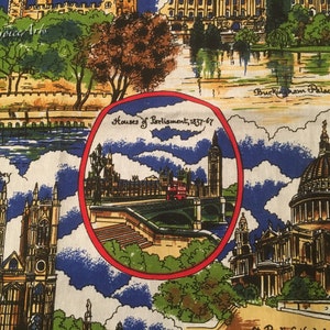 May include: A colorful fabric with a pattern of famous London landmarks, including Buckingham Palace, Houses of Parliament, and Westminster Abbey. The fabric features a blue and white background with red, yellow, and green accents.