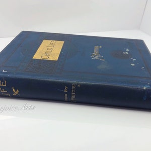 May include: A blue hardcover book titled "Child Life" by John Greenleaf Whittier. The book is in good condition with some wear and tear on the cover.
