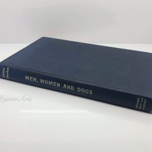 May include: A blue hardcover book titled "Men, Women and Dogs" by James Thurber. The book is published by Harcourt, Brace and Company.