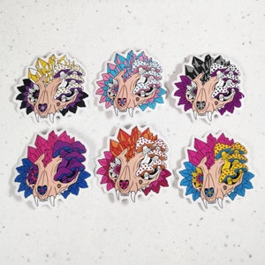May include: Six colorful stickers featuring a skull with crystals and mushrooms. Each sticker has a different color scheme, including pink, purple, blue, yellow, orange, and black.