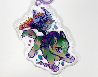 May include: A clear acrylic keychain featuring a cartoon illustration of a character riding a wolf. The wolf is green and purple with blue eyes. The character has orange and yellow hair and wears a silver helmet. A purple clasp is attached.