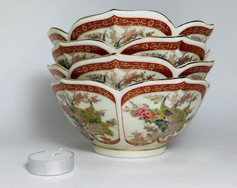 May include: A set of four white porcelain bowls with a red and gold rim and a floral and peacock design.