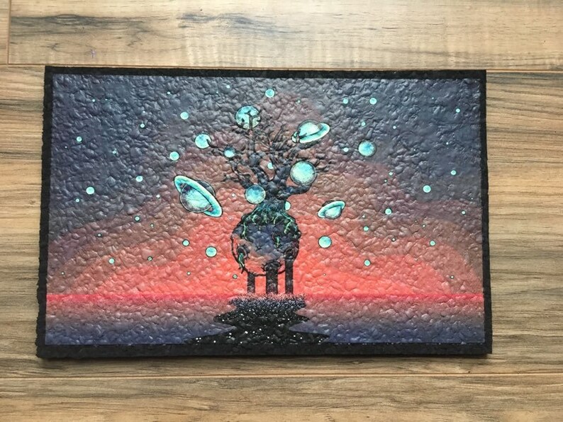 May include: A painting of a tree with a dark blue trunk and branches, with many small, light blue circles around it. The tree is standing on a dark blue surface with a red and orange sunset in the background. The tree has a large, light blue sphere at the top, and many smaller light blue spheres on the branches.