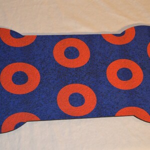 May include: A blue and red bone-shaped doormat with a donut pattern.