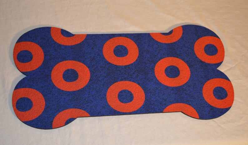 May include: A blue and red bone-shaped doormat with a donut pattern.