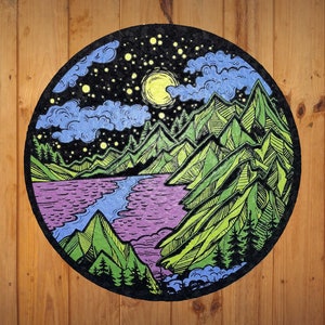 May include: A circular, hand-drawn illustration of a night sky with a full moon, stars, and clouds over a lake surrounded by mountains. The mountains are green and blue, and the lake is purple and blue.