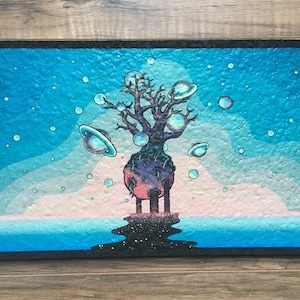 May include: A painting of a tree with a pink and purple planet at its base. The tree is surrounded by blue bubbles and planets with rings. The background is a blue sky with white clouds and a blue ocean.
