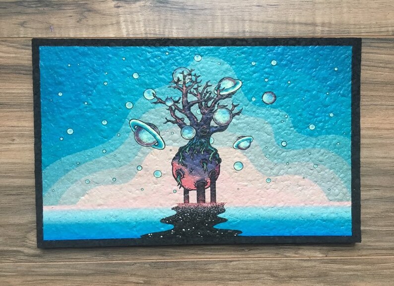 May include: A painting of a tree with a pink and purple planet at its base. The tree is surrounded by blue bubbles and planets with rings. The background is a blue sky with white clouds and a blue ocean.