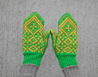 Green yellow hand knitted mittens. Woolen mittens