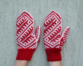 White red woolen hand knitted mittens with traditional baltic pattern