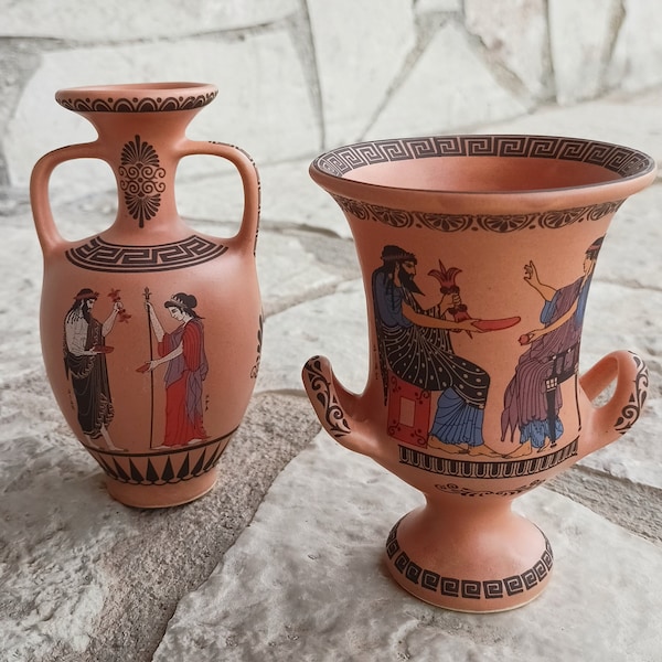 Set of two amphora shape vases, in ocher glaze with black figured designs.