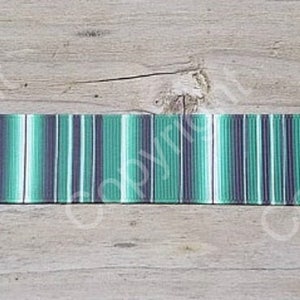 May include: Green, white, and black striped ribbon with a subtle ombre effect. The ribbon is approximately 1 inch wide.