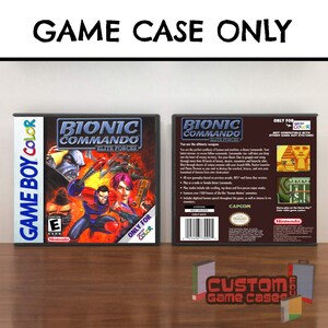 May include: A Bionic Commando Elite Forces video game case for Game Boy Color. The front cover features a character with a bionic arm and a female character with a gun. The back cover displays game information, screenshots, and a barcode.
