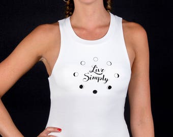 May include: White tank top with a black graphic of a crescent moon and the text "Live Simply".