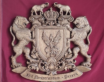 May include: A wooden coat of arms with a carved phoenix, two tigers, and two elephants. The coat of arms has a crown on top and a banner at the bottom that reads "Nil Desperandum - Pererra".