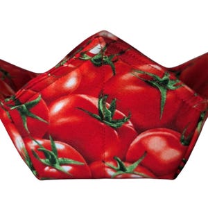May include: Red fabric bowl with a tomato print. The bowl is folded into a cone shape.