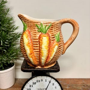 May include: A set of three ceramic vases in varying heights and shapes. The vases are glazed in a matte white finish, offering a minimalist aesthetic. The tallest vase measures approximately 10 inches high.