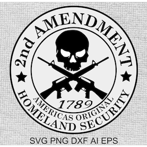 May include: Black and white graphic design of a skull with crossed rifles. The design is in a circle with the text "2nd Amendment" at the top, "Americas Original Homeland Security" at the bottom, and "1789" in the center.