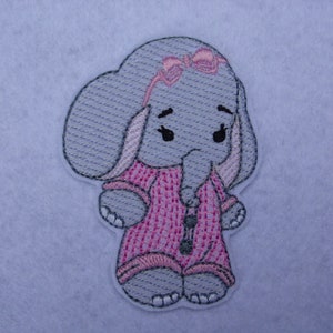 May include: Embroidered patch of a grey elephant wearing pink and white striped pyjamas with a pink bow on its head.