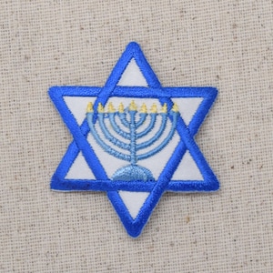 May include: A blue and white embroidered Star of David with a menorah in the center. The menorah has seven yellow flames.