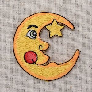 May include: A yellow crescent moon with a smiling face and a small yellow star on top. The moon has a red cheek and a small tongue sticking out.