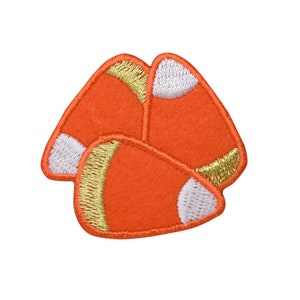 May include: Three orange and white candy corn shaped felt patches with gold stitching.