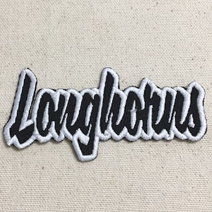 May include: Black and white embroidered patch with the word "Longhorns" in a stylized font.