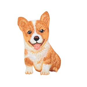 May include: Embroidered patch of a brown and white corgi puppy sitting with its tongue sticking out.