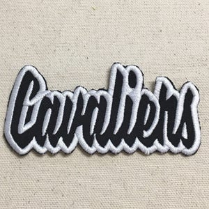 May include: Black and white embroidered patch with the word "Cavaliers" in a stylized font.
