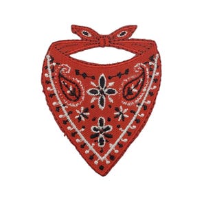 May include: A red bandana-shaped embroidered patch featuring a black and white paisley pattern. The design includes a central floral motif, intricate black and white stitching along the edges, and a knotted top section with a finished border.