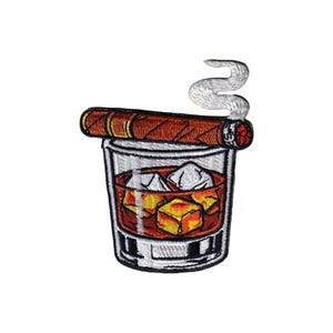 May include: Embroidered patch featuring a glass of whiskey with ice cubes and a lit cigar. The cigar is brown with a red tip, and the whiskey is amber-colored. White smoke curls above the cigar, and the glass has a clear appearance.