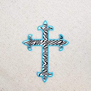 May include: A blue and white zebra patterned cross with a blue outline. The cross is a religious symbol.