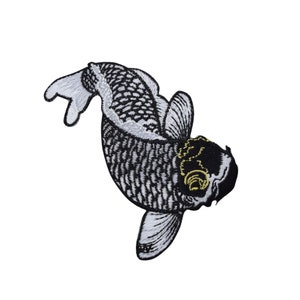 May include: Embroidered patch featuring a koi fish design. The fish is depicted in black and white with detailed scales and fins. The head is black with gold accents. The patch is likely for clothing or accessories.