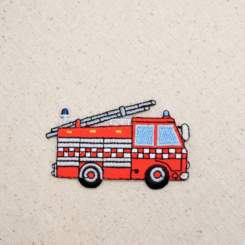 May include: Red and white embroidered fire truck patch with a ladder on top. The truck has a blue light on top and a white stripe around the bottom.
