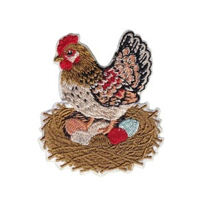 May include: An embroidered iron-on patch featuring a brown and white hen sitting in a golden-brown nest. The hen has a bright red comb and wattle. Inside the nest are three small eggs colored in light blue, red, and white.