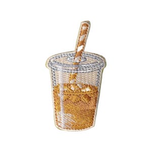 May include: Embroidered patch of an iced coffee drink in a clear plastic cup with a lid and a striped straw. The patch features shades of beige, brown, and white, with detailed stitching. The patch is designed to be ironed on or sewn onto fabric.