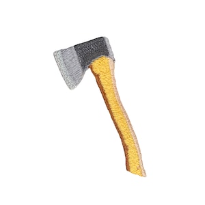 May include: A small, embroidered axe with a gray metal head and a yellow wooden handle.