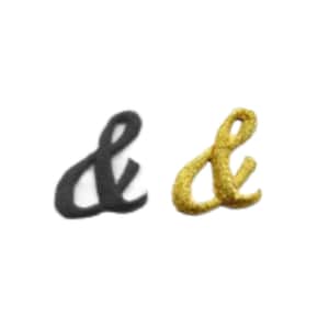 May include: Two embroidered ampersand symbols, one black and one gold.