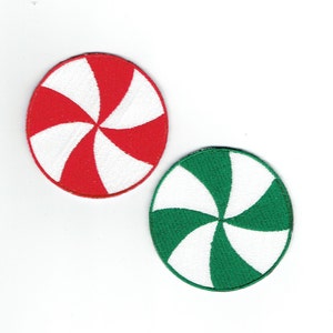May include: Two round, felt, peppermint candy patches. One is red and white, the other is green and white.