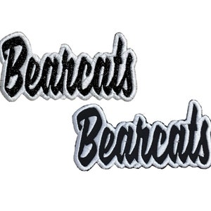 May include: Two black and white embroidered patches with the word "Bearcats" in a stylized font.