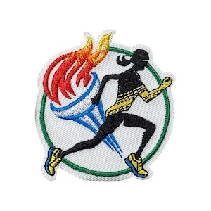 May include: An embroidered patch featuring a silhouette of a runner holding a torch with flames. The runner is wearing a yellow stripe across their chest and is running inside a green circle.