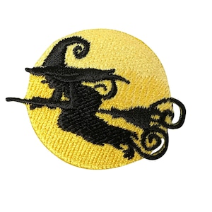May include: Black silhouette of a witch flying on a broomstick in front of a yellow full moon. The witch is wearing a pointed hat and has long hair.
