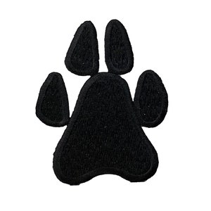 May include: Black felt paw print patch. The patch is shaped like a paw print with four toes and a pad.