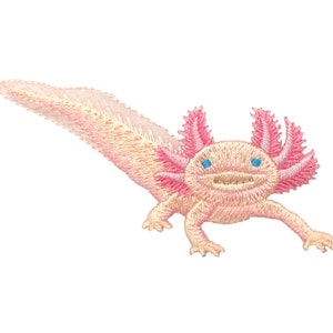 May include: A pink and white embroidered axolotl with blue eyes. The axolotl is a type of salamander that is native to Mexico.