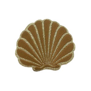 May include: A seashell-shaped patch featuring a solid brown fabric base with textured, shimmering gold glitter lines radiating from the center to the scalloped edges, creating a distinct fan-like pattern with a defined, curved bottom border.