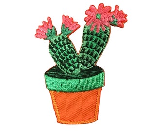 May include: A green cactus with pink flowers in a bright orange pot. The cactus is embroidered and has a 3D effect.